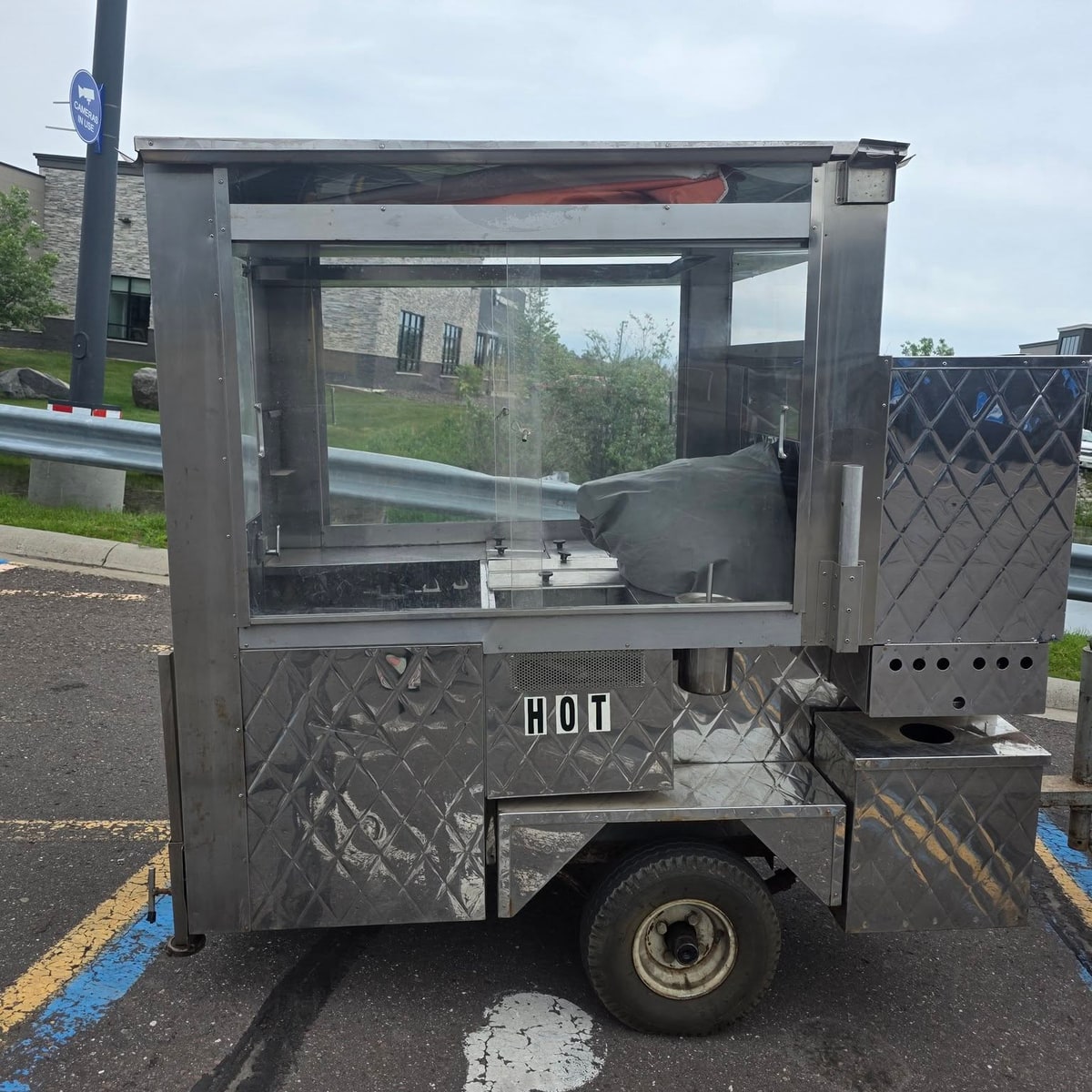 The stainless steel Sugar Rush hot dog cart with its glass service window