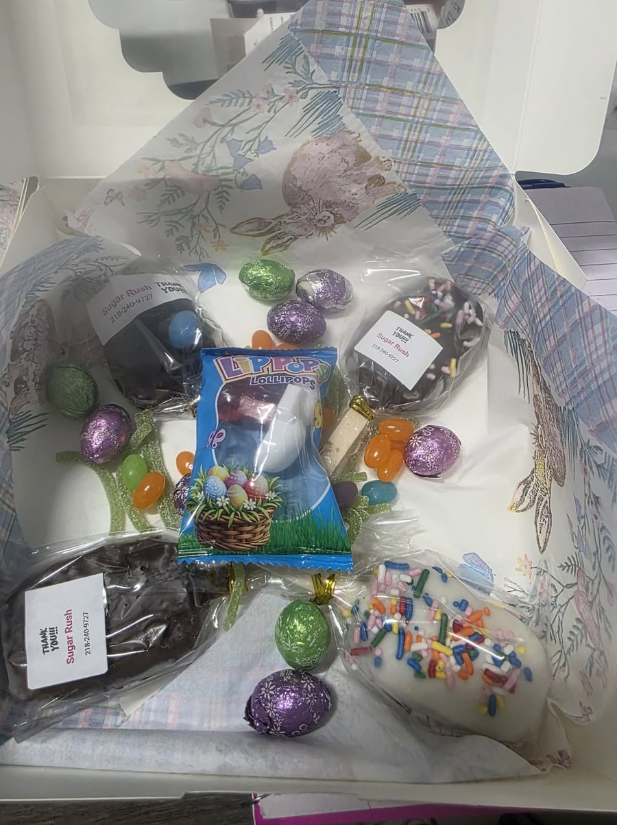 Easter gift box with cakesicles, foil chocolate eggs, jelly beans, and a lollipop