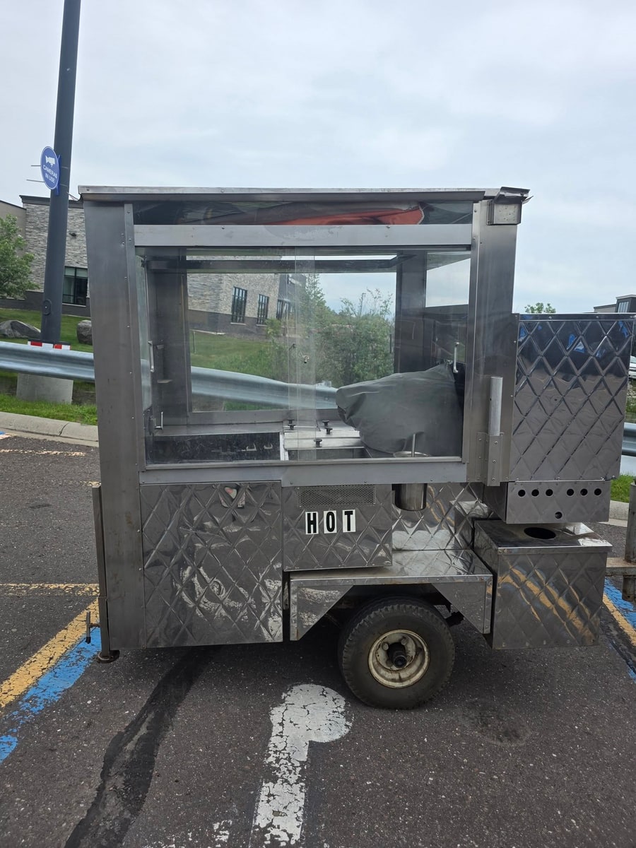 The stainless steel Sugar Rush hot dog cart with its glass service window