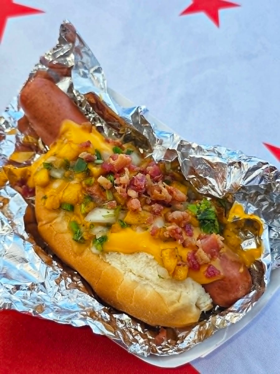 Peachy Keen hot dog with melted cheddar, bacon, and diced jalapeno